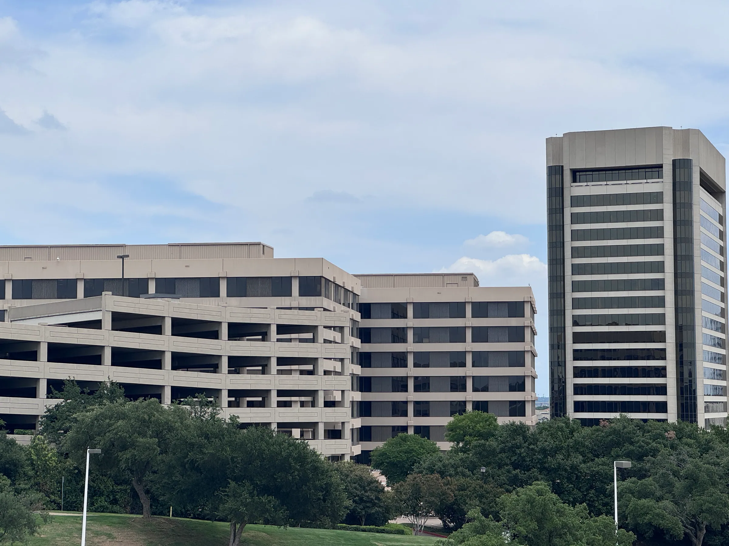 Mid-rise office buildings and an office tower in Dallas–Fort Worth