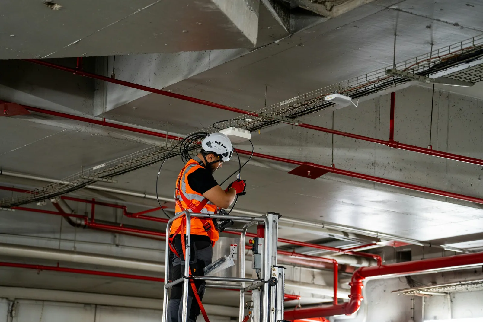 Technician on a lift working at a commercial ceiling